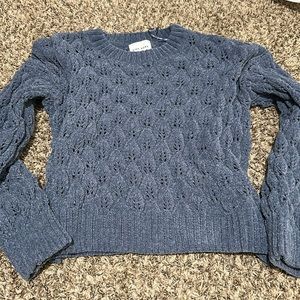 Super soft sweater with eyelet detailing!